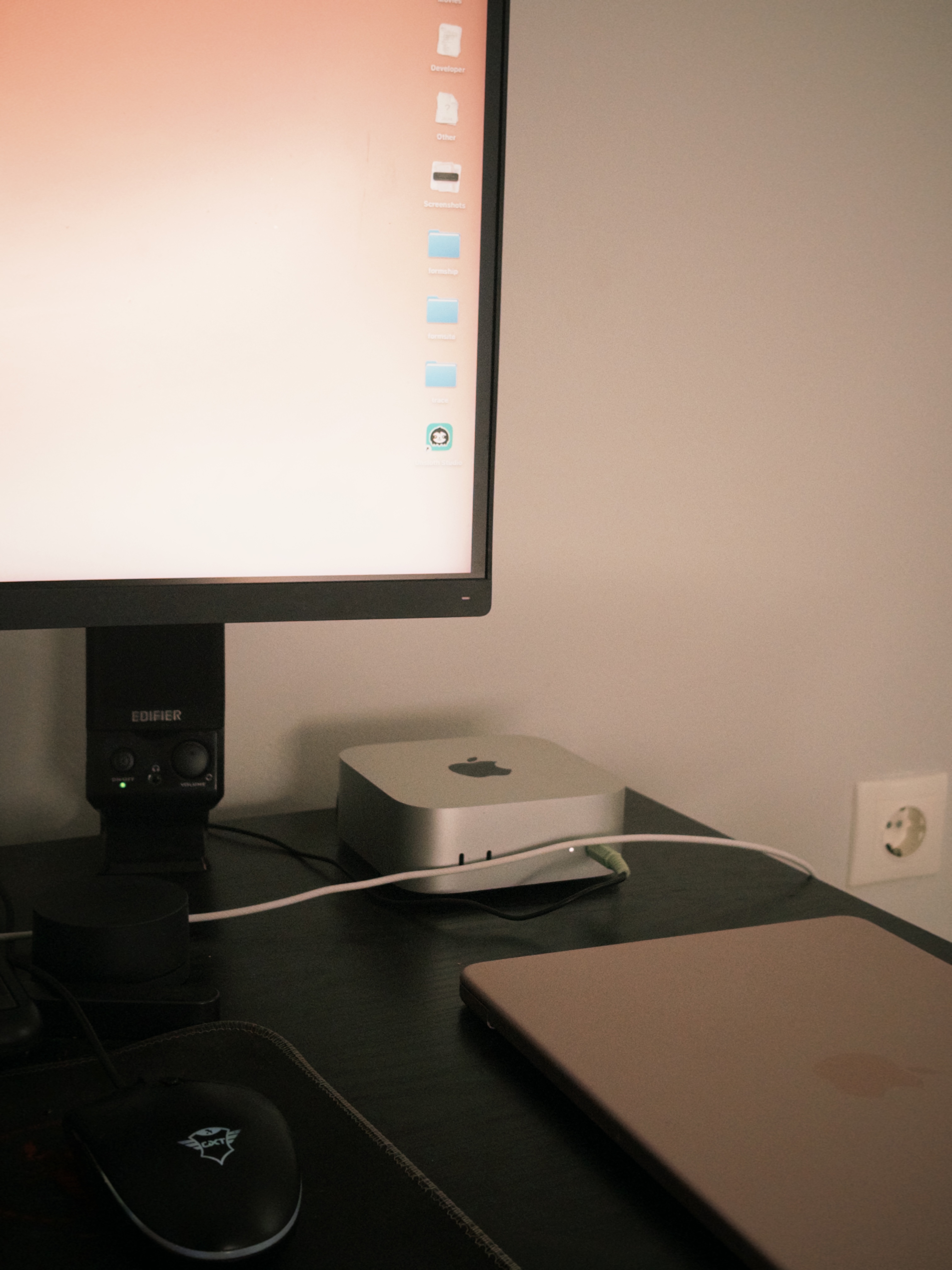 A Mac mini and a monitor on a desk